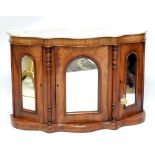 A small Victorian walnut and inlaid marble topped credenza of serpentine outline, with mirrored