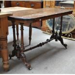 A Victorian walnut centre table with rectangular top and turned end supports (af).