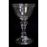 A mid-18th century English sweetmeat glass, the ogee shaped bowl with cut rim and decorated with a