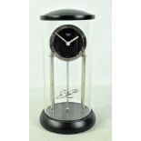 RAPPORT; a modern battery operated mantel clock with Roman numerals and perpetual motion effect