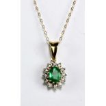 A 9ct yellow gold cluster pendant set with oval cut emerald within a border of melee diamonds in