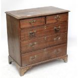 An early 19th century oak and mahogany crossbanded chest of two short and three long drawers