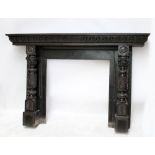 A large Victorian oak fire surround with gadrooned mantel above elaborately carved and turned jambs,