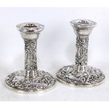 WI BROADWAY & CO; a pair of Elizabeth II hallmarked silver squat candlesticks with repoussé