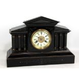 A late 19th century black painted wooden mantel clock of architectural form, the porcelain chapter