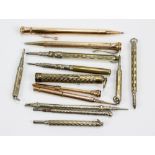 A group of gold plated propelling pencils including engine turned and foliate decorated examples,