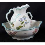 A Victorian twin handled toilet jug and bowl, both with foliate decoration and impressed