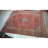 A large modern red ground carpet, 385 x 295cm.Additional InformationThe carpet is heavily worn and