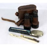 A pair of early 20th century binoculars by Dollond of London in fitted leather case, a carved bone