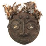 An African tribal mask, Dan, with rattan woven backing, shell eyes and feather adornment, diameter