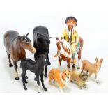 A small group of Beswick comprising mounted Indian, three horses including two matte black examples,