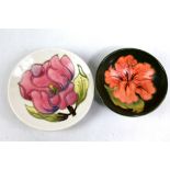 MOORCROFT; a 'Hibiscus' pattern tubeline decorated green ground small bowl, diameter 9.2cm, and a '