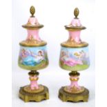 SEVRES; a pair of painted porcelain gilt metal mounted late 19th century cassolettes, each with gilt