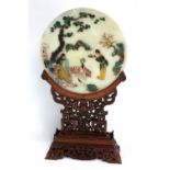 A 20th century decorative Chinese screen with hardstone inlay and mounted on a pierced wooden frame,