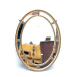 An early 20th century gilt framed oval wall mirror with beaded decoration, length 84cm.