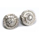 A pair of 10ct white gold and diamond circular stepped cluster ear studs, each centred with a