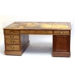 An early 20th century mahogany partners desk with three frieze drawers to both sides, three