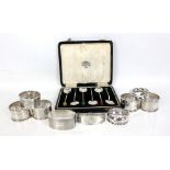 Eight variously hallmarked silver napkin rings to include an engine turned decorated example,