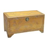 A Chinese camphor wood chest with carved decoration of bamboo tree within stylised border to