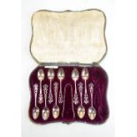 ELKINGTON & CO; a cased set of ten George V hallmarked silver coffee spoons with pierced finials,