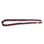 A graduated cherry amber coloured bead necklace, length 55cm.