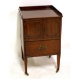 A 19th century mahogany night cupboard with tapering square supports on brass castors, height 80cm.