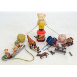 A Japanese clockwork teddy bear toy, two further clockwork tinplate toys and small group of