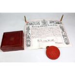 A George V indenture complete with attached wax seal in original tin and in gilt tooled leather