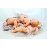 A group of early 20th century dolls and body parts including German bisque head in good condition,
