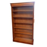 A reproduction yew wood freestanding open bookcase, width approx 100cm.