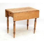 A late 19th century pine Pembroke table raised on ring turned legs.Additional InformationThe flap
