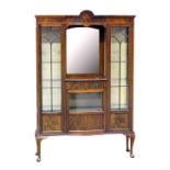 An Edwardian mahogany display cabinet with recessed mirrored back and raised on cabriole legs, width