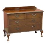 An early 20th century mahogany chest of two short and two long drawers raised on squat cabriole