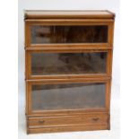 GLOBE-WERNICKE; a pair of oak three section stacking bookcase with lower base drawer, width 87cm.