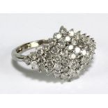 A platinum and diamond ring, the lozenge shaped platform paved with round cut melee diamonds in claw