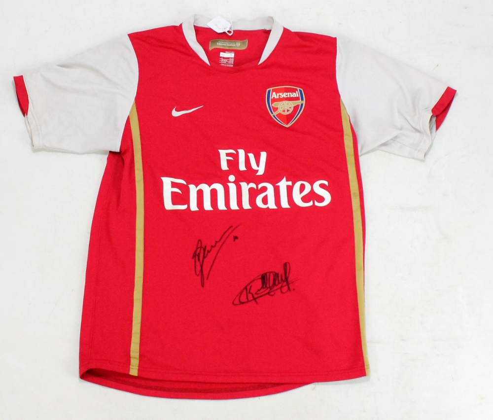 DENNIS BERGKAMP AND THIERRY HENRY; a signed replica Arsenal football shirt.