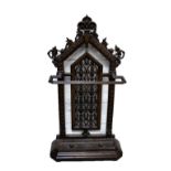 A Victorian cast iron stick stand with pierced arched back and shaped drip tray.