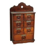 A set of circa 1900 oak and beech spice drawers set with seven drawers inscribed 'Clove', '