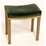 An Elizabeth II coronation stool with padded seat and limed oak legs.