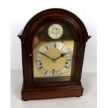 A mahogany cased Westminster chime mantel clock, the silvered chapter rings set with Roman and