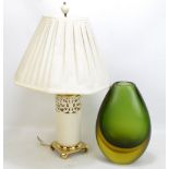 A porcelain pierced lamp with brass base, height 56cm, and a green glass vase (2).