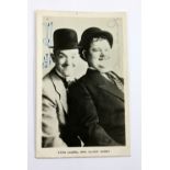 STAN LAUREL AND OLIVER HARDY; a signed black and white photograph, 14 x 8.7cm.Additional