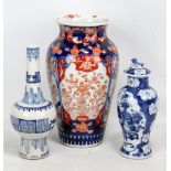 An early 20th century Chinese porcelain bottle vase with slender neck and tall spreading foot,