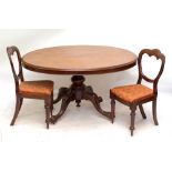 A Victorian mahogany oval loo table raised on four scrolling supports and a set of six late