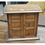 An oak table top cabinet with twin doors enclosing three shelves, 40.5 x 44cm.