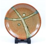 JAMES HAKE (born 1979); a stoneware dish covered in shino glaze with nuka ash decoration,