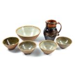 Leach Pottery; a stoneware jug covered in tenmoku breaking to khaki glaze, impressed pottery mark,