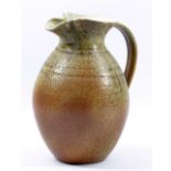WILL ILLSLEY (born 1948); a stoneware jug partially covered in running green ash glaze, impressed WI