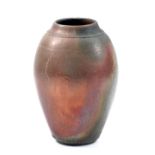 BRUCE CHIVERS (born 1954); a raku vase with lustrous red and smoky black surface decoration,