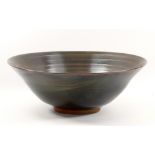 GWYN HANSSEN-PIGOTT (1935-2013); a large early stoneware footed bowl covered in tenmoku breaking